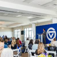 Photo overlooking crowd as Dr. Nick Ceglarek gives his remarks at podium